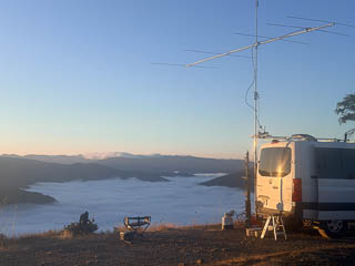 K7BWH rover van parked above cloud-filled valley at sunrise